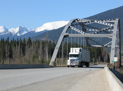 truck driving over bridge